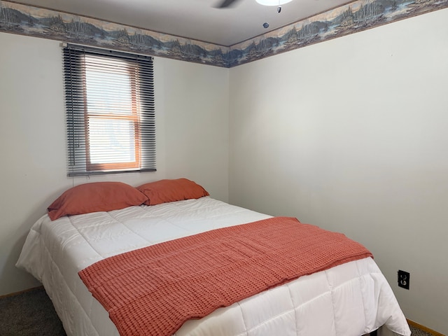 bedroom with a ceiling fan and carpet flooring