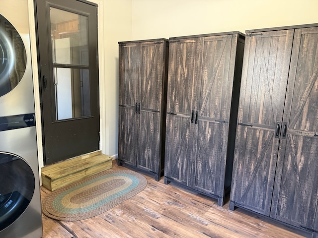 interior space with stacked washing maching and dryer