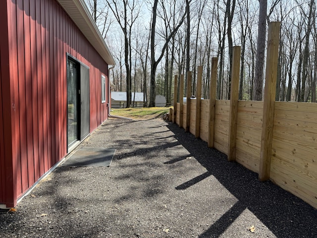 view of side of property featuring fence