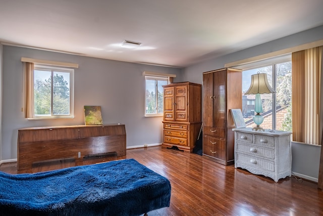 bedroom featuring baseboards, dark wood-type flooring, and visible vents