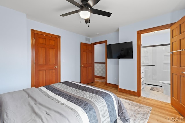 bedroom with connected bathroom, light wood-style floors, a ceiling fan, visible vents, and baseboards