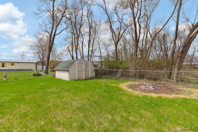 view of yard with an outbuilding, a shed, and a fenced backyard