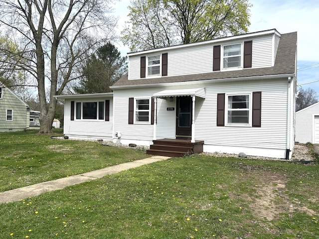 bungalow-style house with a front lawn, entry steps, and roof with shingles