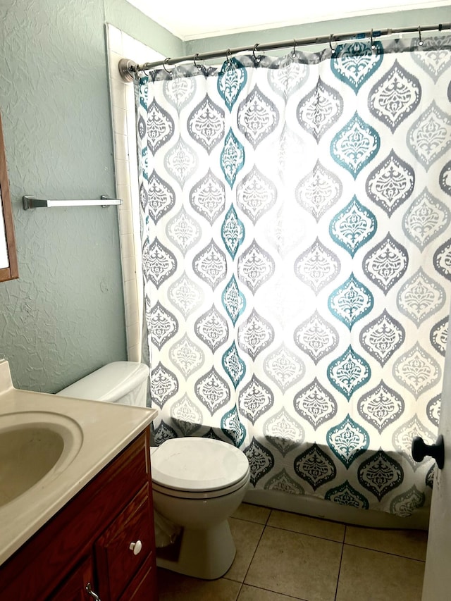 bathroom with vanity, tile patterned floors, toilet, a textured wall, and a shower with shower curtain