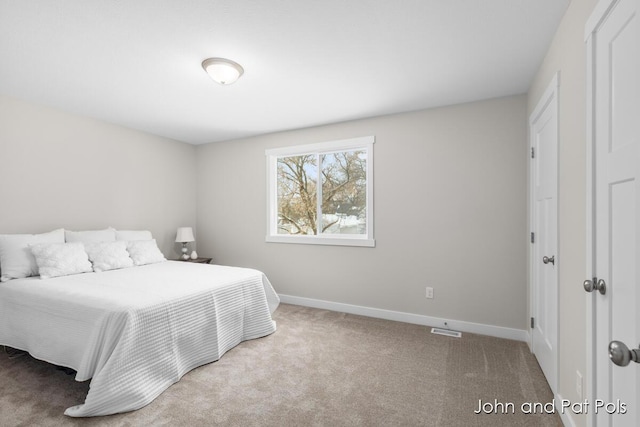 bedroom featuring carpet, visible vents, and baseboards
