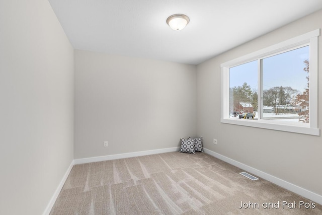 empty room with visible vents, carpet, and baseboards