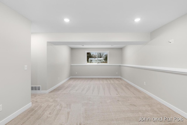 below grade area with baseboards, visible vents, carpet floors, and recessed lighting