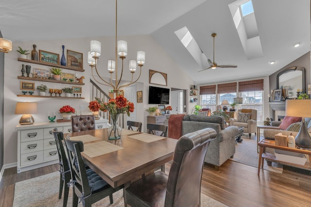 dining room featuring ceiling fan, high vaulted ceiling, recessed lighting, wood finished floors, and a skylight