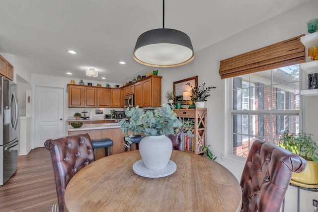 dining area with dark wood-style flooring and recessed lighting