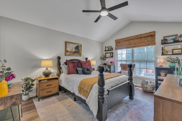 bedroom featuring baseboards, a ceiling fan, lofted ceiling, and wood finished floors