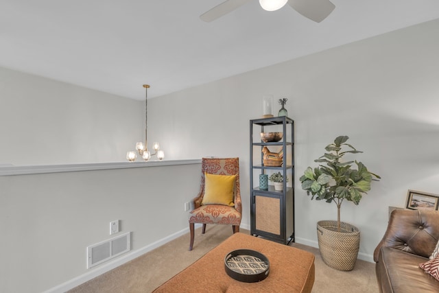 sitting room featuring carpet flooring, baseboards, and visible vents