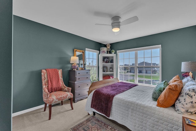 bedroom featuring baseboards, ceiling fan, and carpet flooring