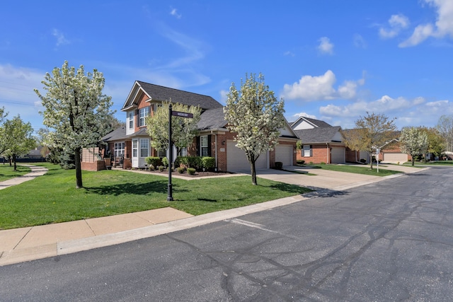view of front facade with an attached garage, a front lawn, brick siding, and concrete driveway