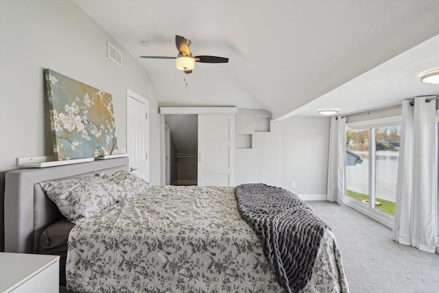 bedroom featuring ceiling fan, visible vents, access to exterior, vaulted ceiling, and carpet flooring