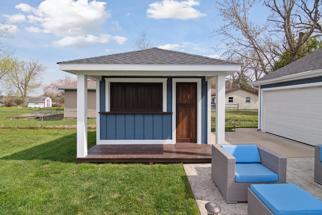 view of outbuilding with an outdoor structure and fence