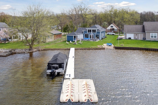 dock area featuring boat lift, a water view, and a yard