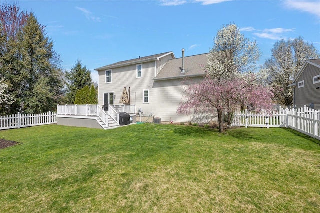 back of house with a deck, central AC, a fenced backyard, and a yard