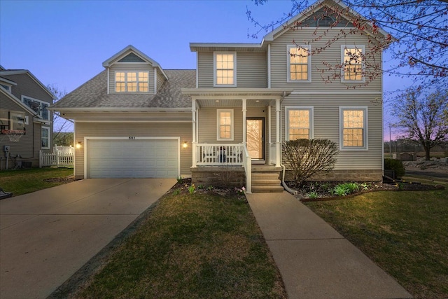traditional-style home featuring covered porch, a garage, a front yard, and concrete driveway