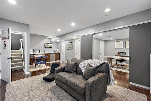 living area with recessed lighting, stairway, bar area, and dark wood-type flooring