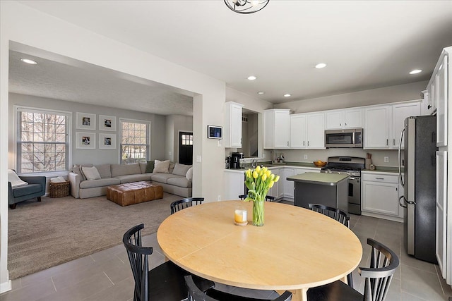 dining space with recessed lighting, tile patterned flooring, and plenty of natural light