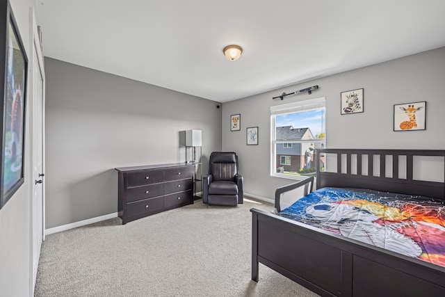 bedroom featuring baseboards and carpet flooring