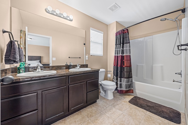 bathroom featuring toilet, shower / bath combo, a sink, and visible vents
