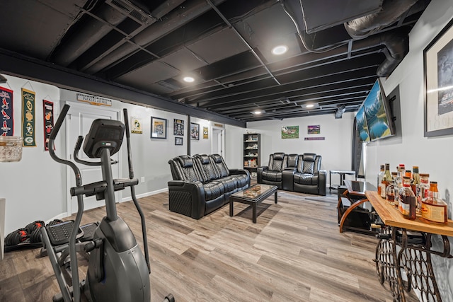 workout area featuring light wood-style flooring