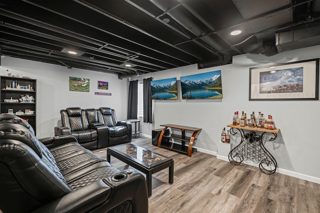 home theater room with wood finished floors and baseboards