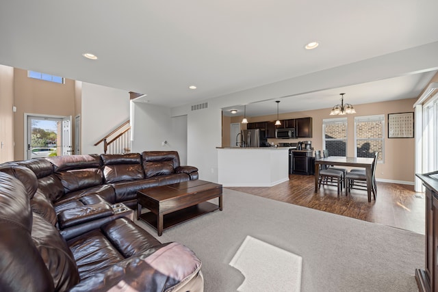 living room with recessed lighting, dark wood-style flooring, a chandelier, stairs, and visible vents