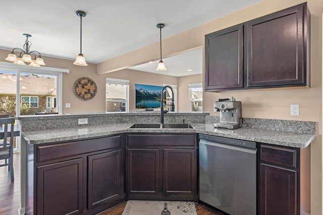 kitchen with a wealth of natural light, dark brown cabinetry, stainless steel dishwasher, and a sink