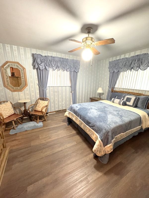 18337 Greenwald Dr, Southfield, MI 48075 - bedroom with a ceiling fan, wallpapered walls, and wood finished floors