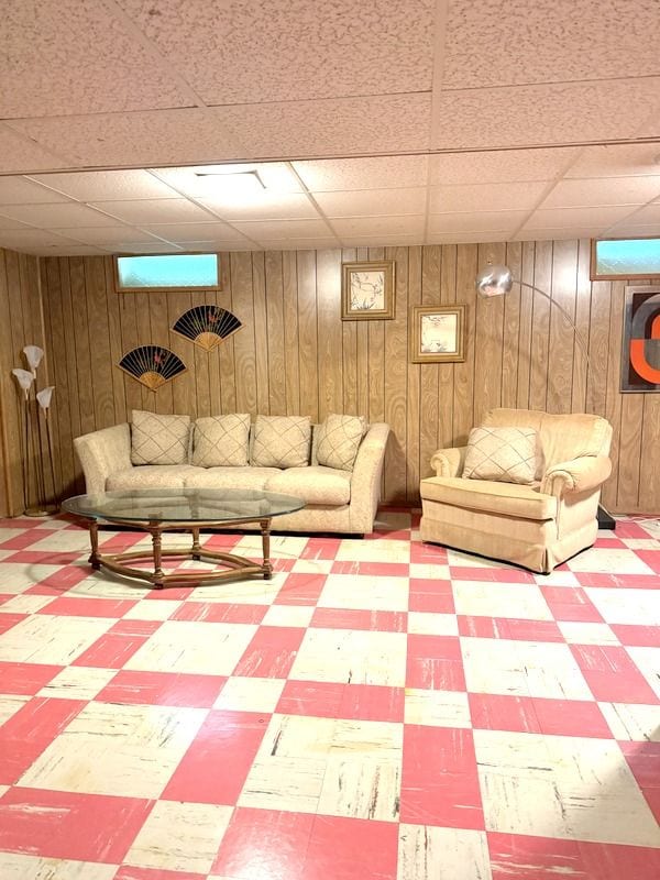 18337 Greenwald Dr, Southfield, MI 48075 - living area featuring a paneled ceiling, tile patterned floors, and wooden walls