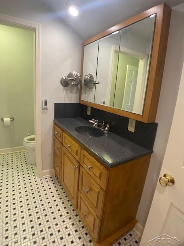 68 Davis Dr, Saginaw, MI 48602 - half bathroom with vanity, toilet, and baseboards