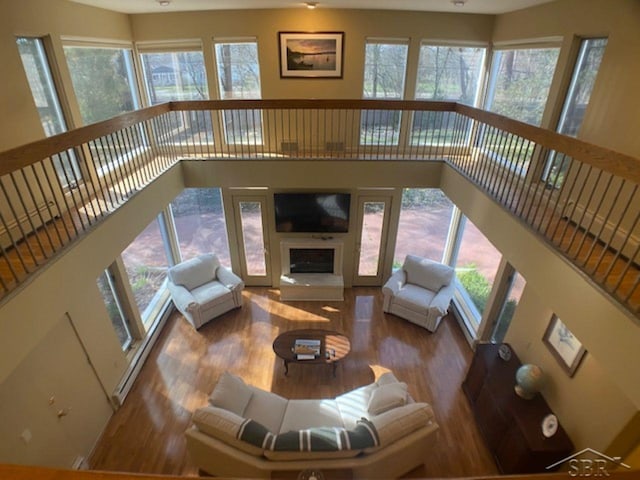 68 Davis Dr, Saginaw, MI 48602 - living room featuring wood finished floors, a high ceiling, and a fireplace