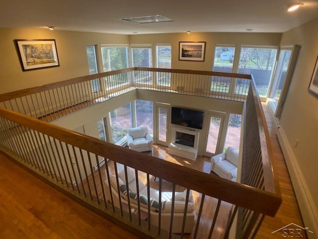 68 Davis Dr, Saginaw, MI 48602 - living area featuring wood finished floors, a fireplace with raised hearth, a healthy amount of sunlight, and baseboards