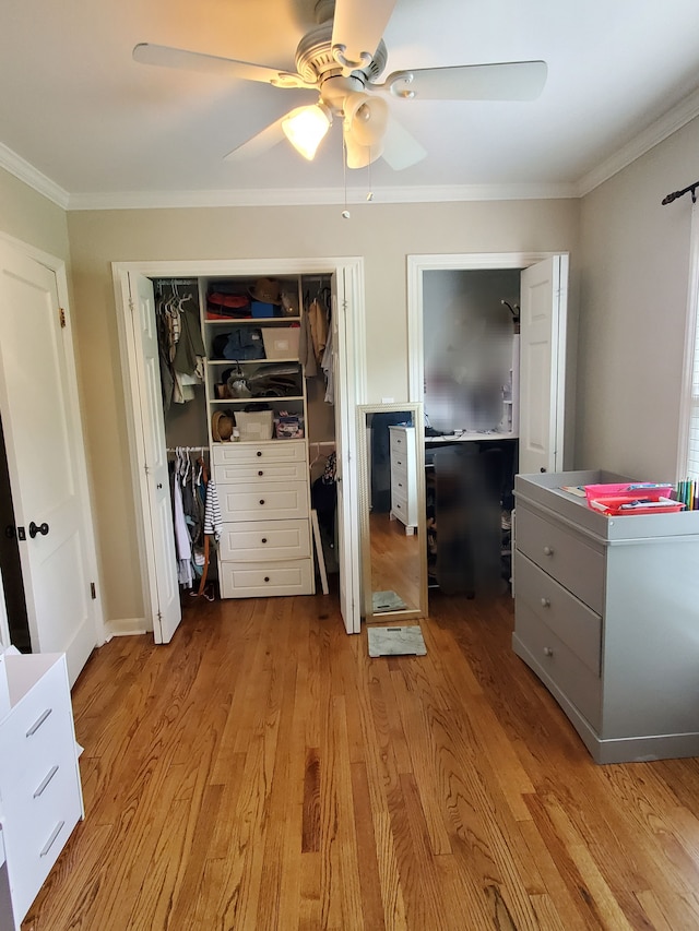 bedroom featuring ceiling fan, ornamental molding, a closet, and wood finished floors