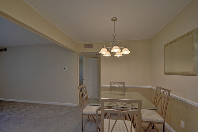 dining space with crown molding, carpet floors, visible vents, and a notable chandelier