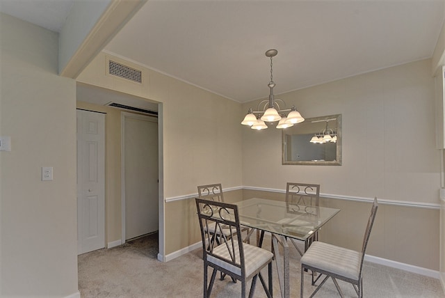 dining area with light colored carpet, baseboards, visible vents, and a chandelier