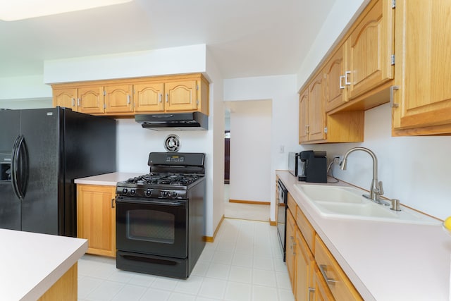 kitchen featuring a sink, under cabinet range hood, black appliances, and light countertops
