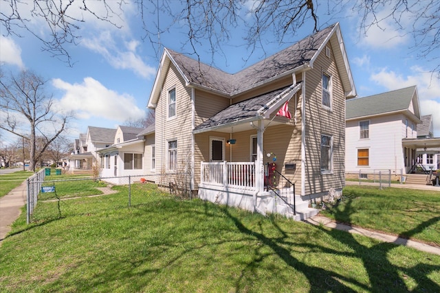 701 N Saginaw St, Durand, MI 48429 - view of side of property featuring a lawn, fence, and covered porch