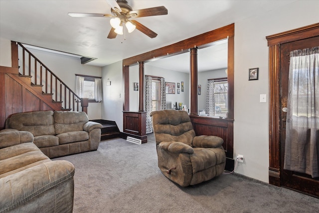 701 N Saginaw St, Durand, MI 48429 - living room with carpet floors, a ceiling fan, ornate columns, and stairway