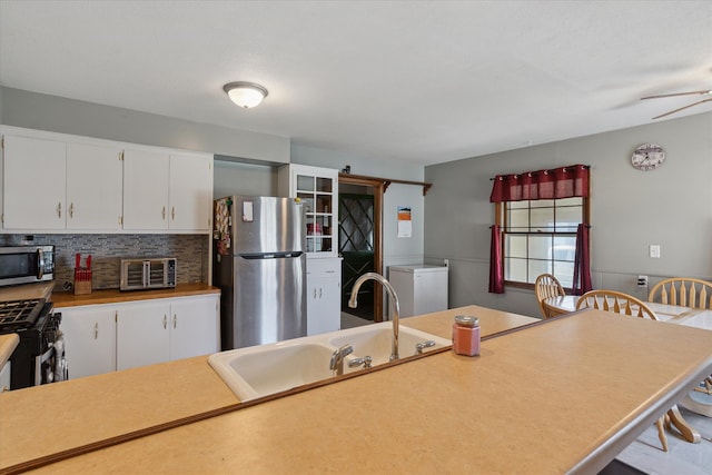 701 N Saginaw St, Durand, MI 48429 - kitchen with a sink, white cabinetry, a toaster, and stainless steel appliances