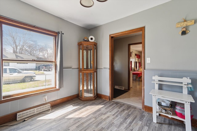 701 N Saginaw St, Durand, MI 48429 - empty room featuring wainscoting, wood finished floors, and visible vents