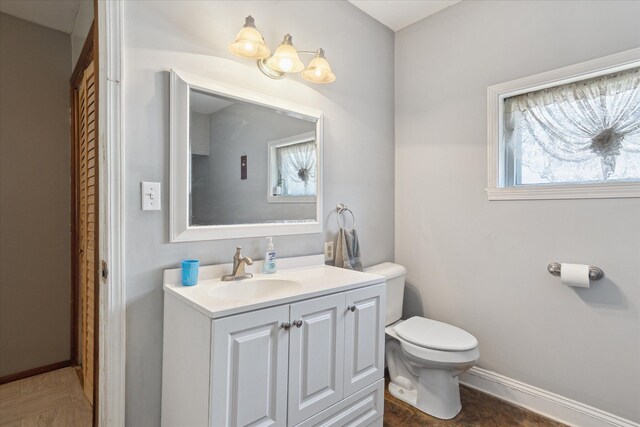 701 N Saginaw St, Durand, MI 48429 - half bath with toilet, baseboards, and vanity
