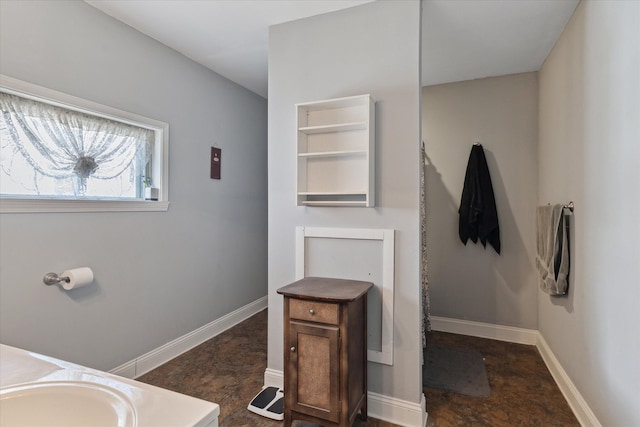 701 N Saginaw St, Durand, MI 48429 - bathroom featuring baseboards and a sink