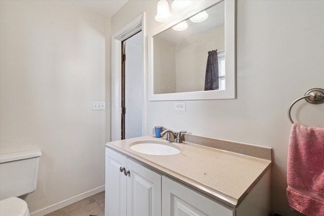 701 N Saginaw St, Durand, MI 48429 - bathroom featuring vanity, baseboards, and toilet
