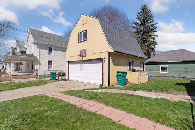 701 N Saginaw St, Durand, MI 48429 - view of side of home featuring a barn, roof with shingles, a lawn, an outbuilding, and a garage