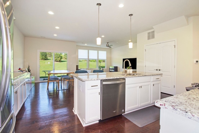 kitchen featuring pendant lighting, a sink, appliances with stainless steel finishes, visible vents, and dark wood finished floors