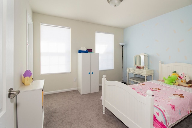 bedroom with light colored carpet, baseboards, and multiple windows