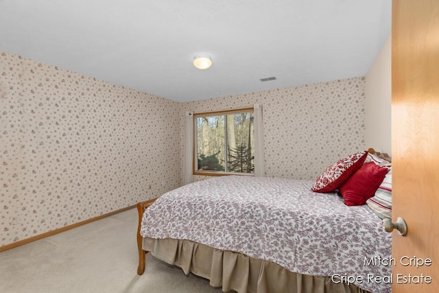 carpeted bedroom featuring visible vents and wallpapered walls